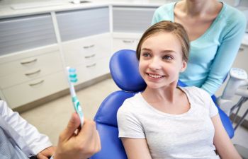 A schoolgirl at a dental appointment.