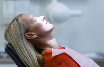 Woman in a dental chair before dental surgery.