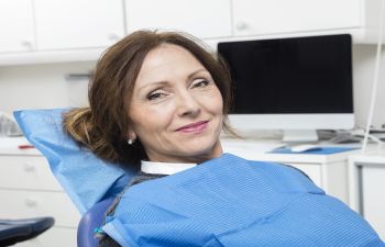 A relaxed satisfied woman in a dental chair.