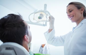 A man in a dental chair during a dental appointment.