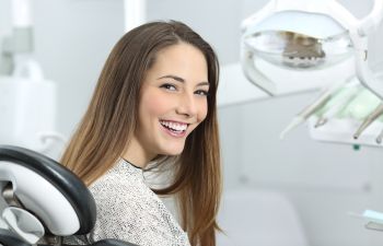 Smiling young woman in a dental chair.