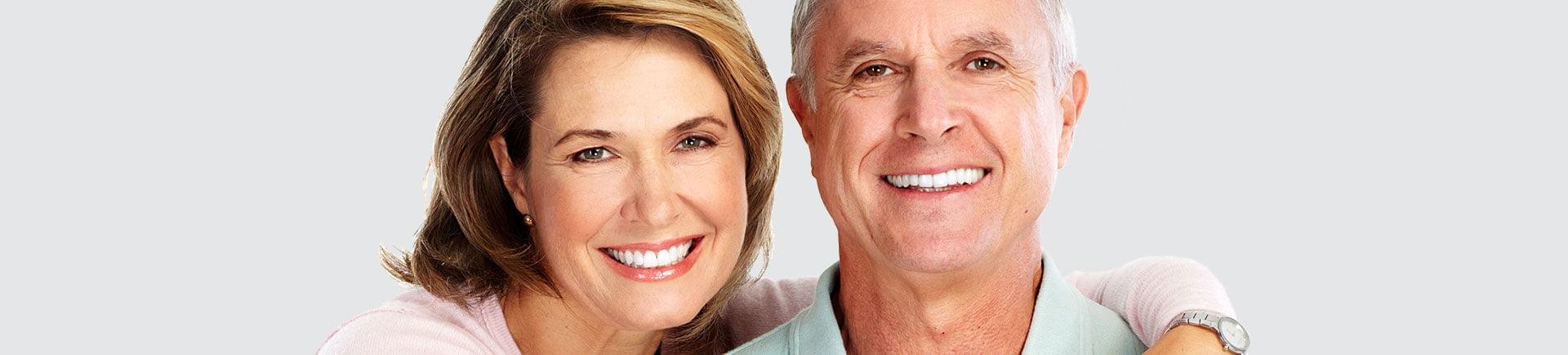 Happy elderly couple with perfect smiles.