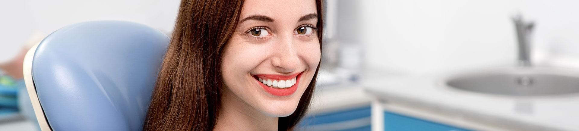 A young woman with a perfect smile after Clear Correct treatment.