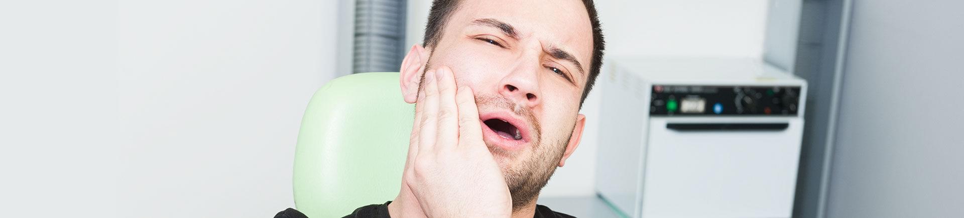 A man suffering from severe tooth pain.