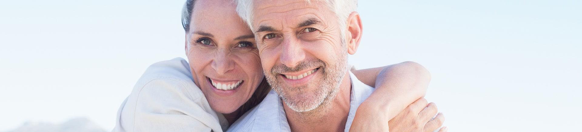 Happy elderly couple with perfect smiles.