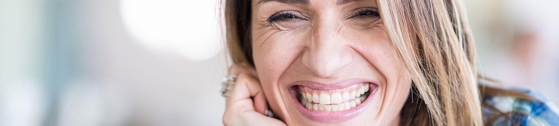 A happy woman showing perfect teeth in her smile.