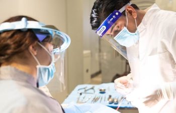 Dr. Dalla and assistant performing a dental procedure