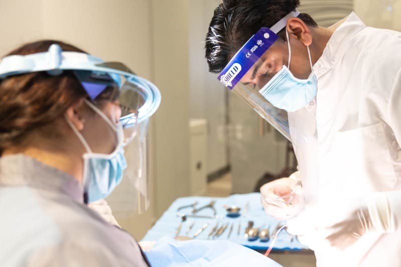 Dr. Dalla and assistant performing a dental procedure