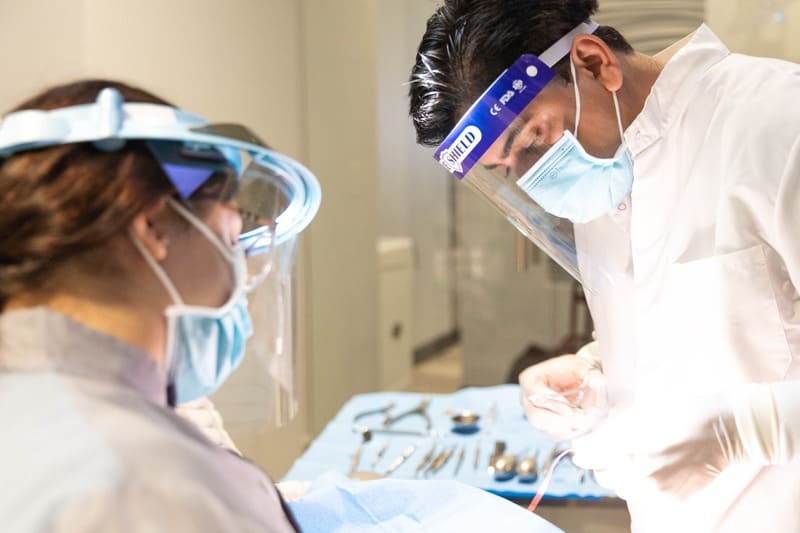 Dr. Dalla and assistant performing a dental procedure